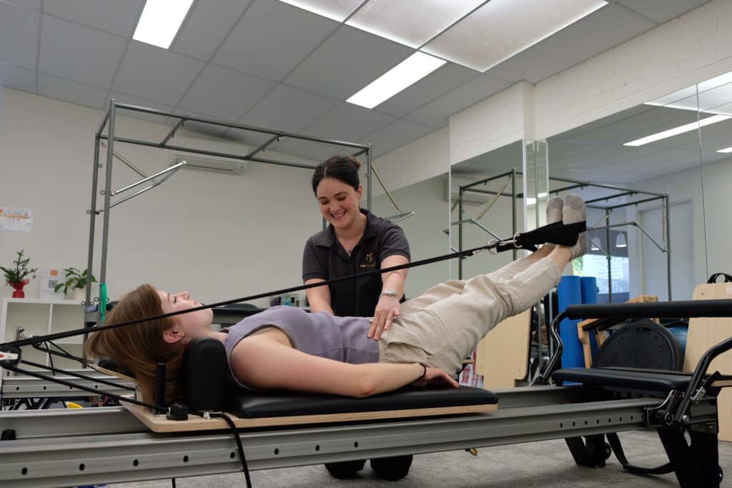Small Clinical Pilates group building core strength under physiotherapist supervision. 