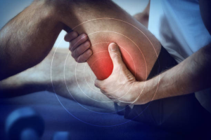 A person holding their lower leg in pain, with a red highlight and circular graphics emphasizing the area, suggesting a Hamstring Muscle Strain or injury.